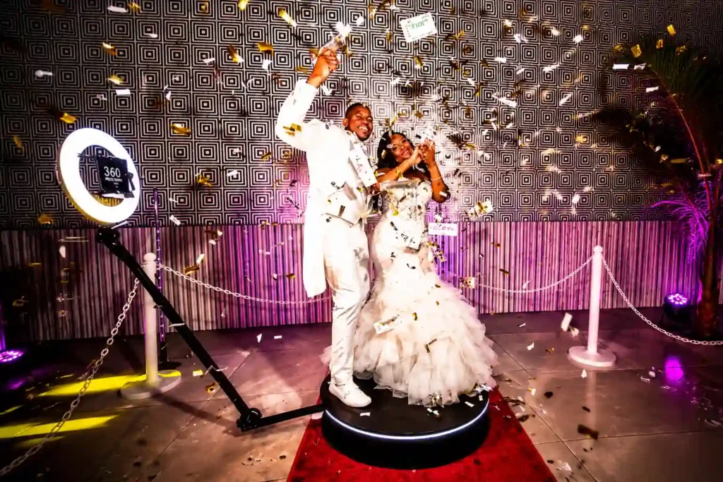 Bride and groom creating memorable wedding content on a 360 video booth.