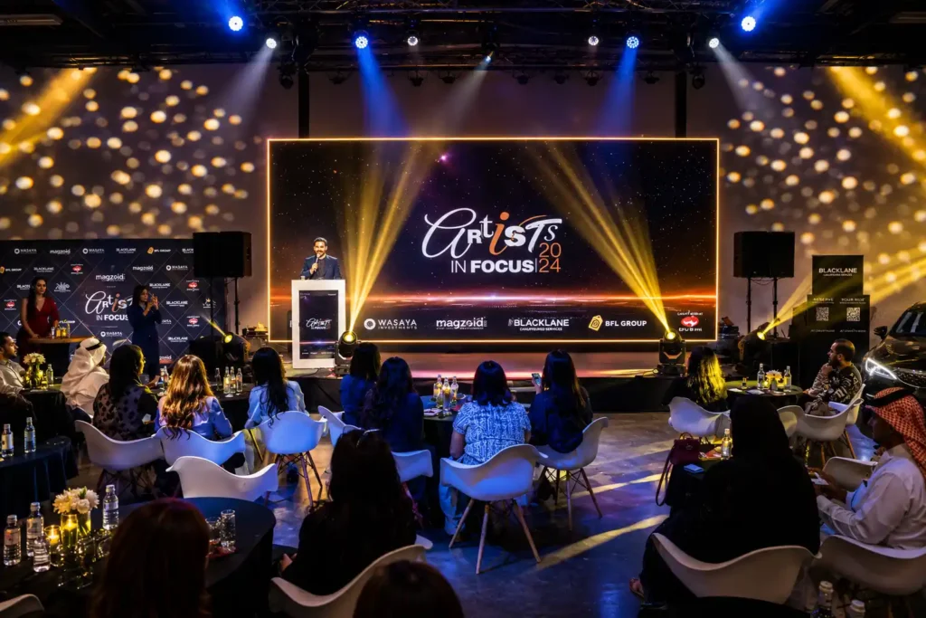 Professional event host presenting on stage at a luxury corporate event in Dubai featuring LED screens, stage lighting, audience engagement and experiential brand activation.
