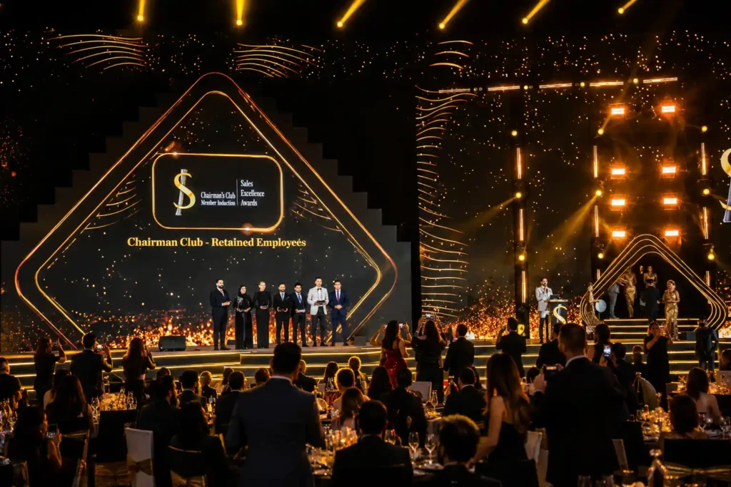 orporate awards ceremony in Dubai featuring a large LED stage, professional event lighting, luxury gala dinner setup and live event hosting for an audience of business professionals.